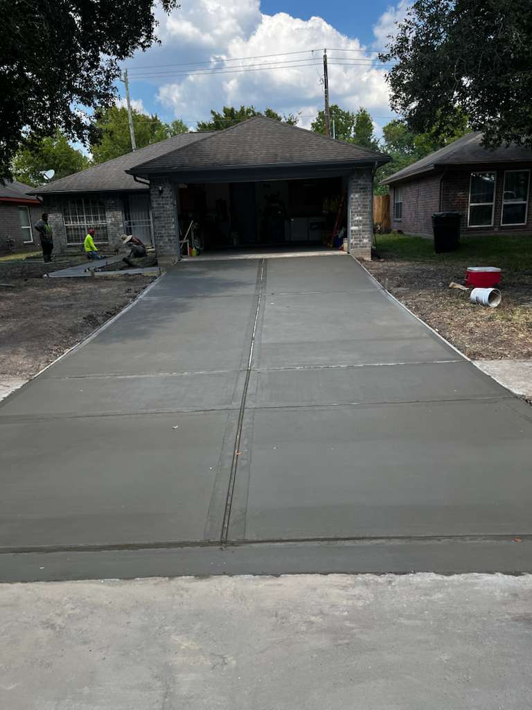 Fresh concrete driveway poured by Zuno Construction in Houston